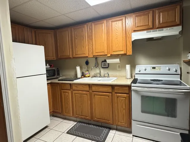 a kitchen with a sink cabinets and stainless steel appliances