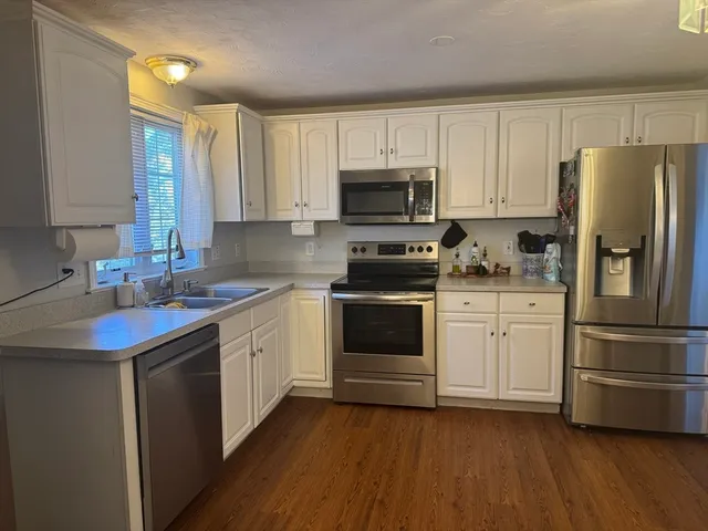 a kitchen with a white cabinets and stainless steel appliances