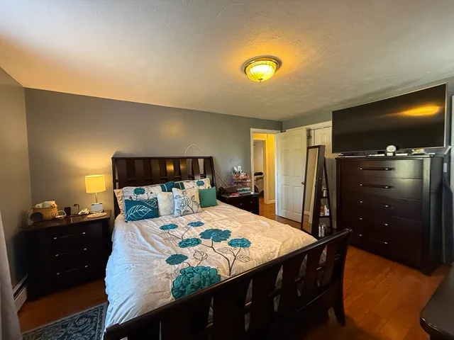 a bedroom with a bed and a dresser