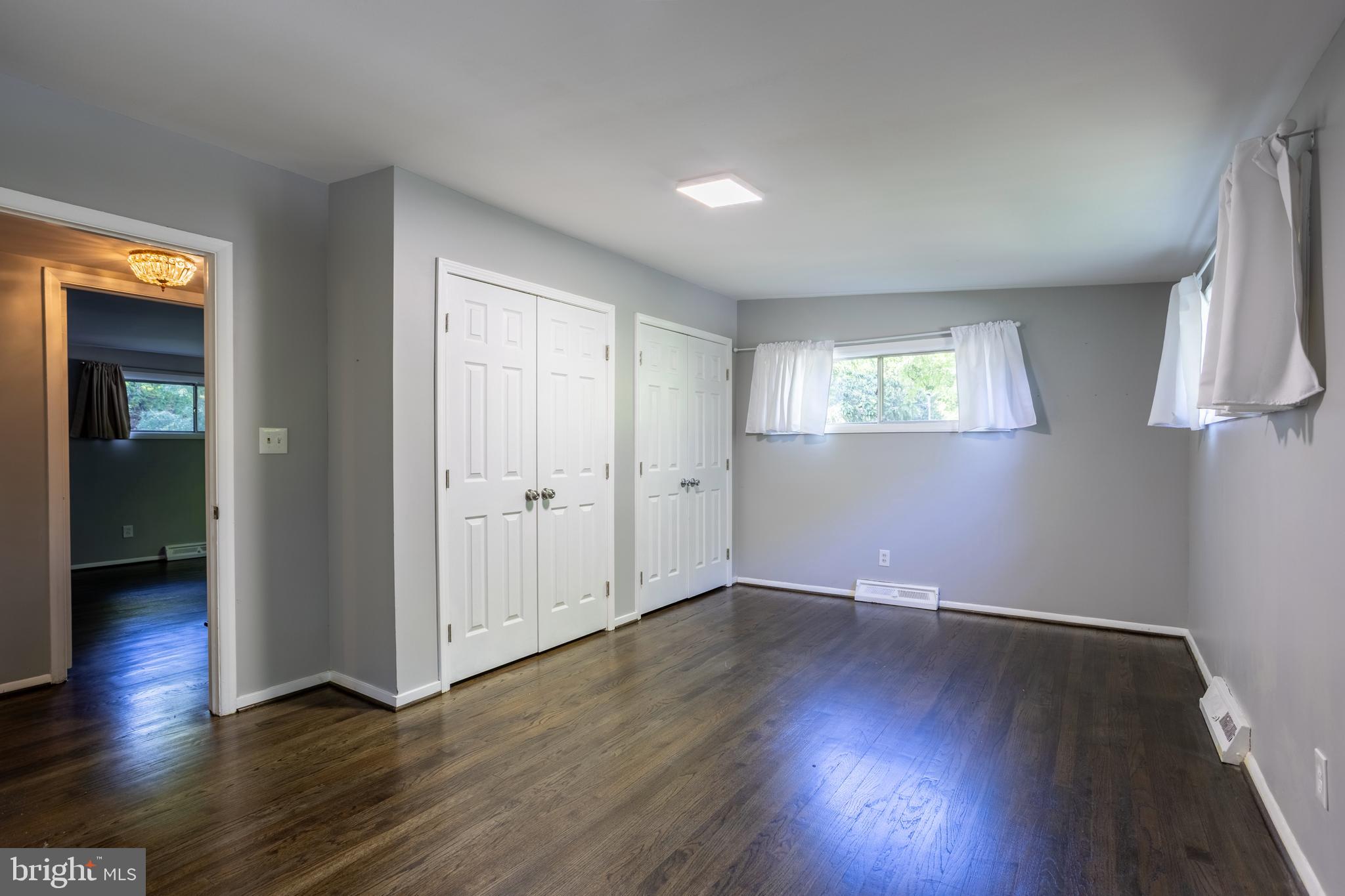 3207 Midfield Road Pikesville, MD 21208 - Photo 18 of 45 an empty room with wooden floor and windows