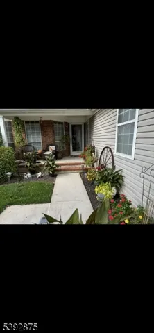 a view of a backyard with table and chairs under an umbrella
