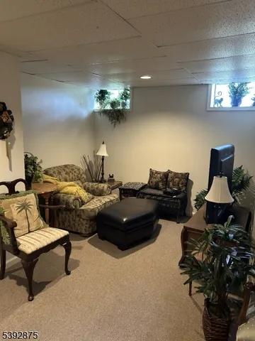 a living room with furniture and a lamp