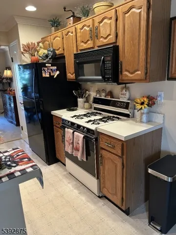 a kitchen with stainless steel appliances granite countertop a stove and a microwave