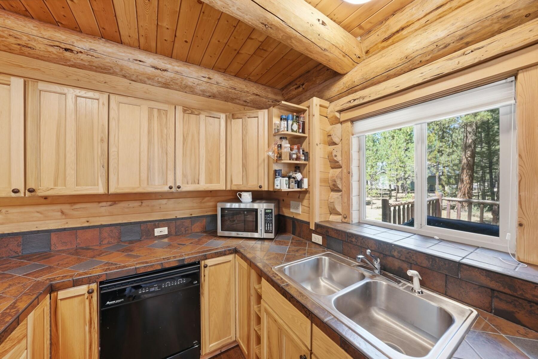 14177 Whitewater Loop La Pine, OR 97739 - Photo 9 of 38 a kitchen with stainless steel appliances granite countertop a sink a counter space and a window