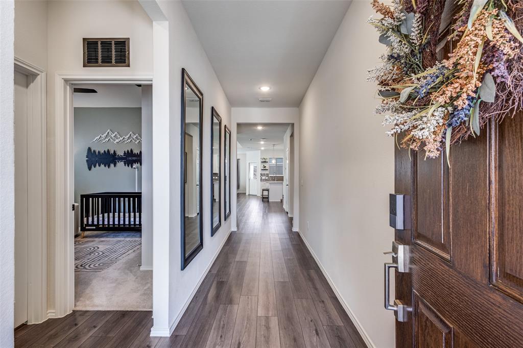 1810 Hummingbird Street Princeton, TX 75407 - Photo 4 of 25 Upon entering you'll be greeted by a grand entrance. It's perfect for hello's and lingering goodbyes. Vinyl luxury plank throughout the home. Carpet in bedrooms only.