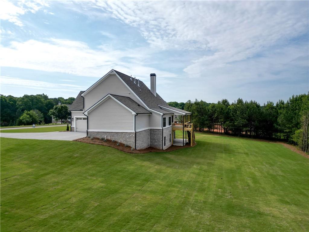 2113 Stonegate Way Monroe, GA 30656 - Photo 7 of 43 a house that is sitting in the grass with large trees