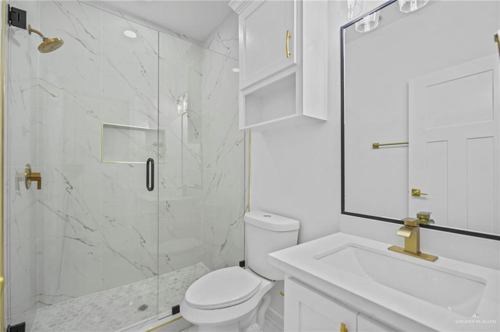2732 East Conroe Road Edinburg, TX 78542 - Photo 11 of 15 a bathroom with a sink a toilet and shower