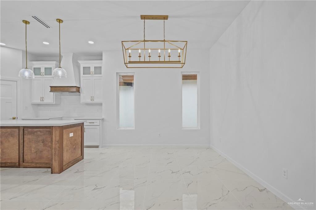 2732 East Conroe Road Edinburg, TX 78542 - Photo 3 of 15 a bathroom with a sink a toilet and a mirror