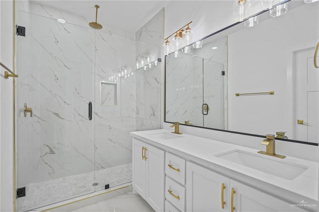 2732 East Conroe Road Edinburg, TX 78542 - Photo 8 of 15 a bathroom with a shower sink and mirror