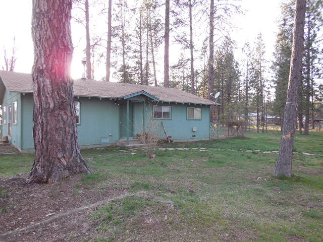 26980 Walker Road Fall River Mills, CA 96028 - Photo 12 of 15 a backyard of a house with lots of green space