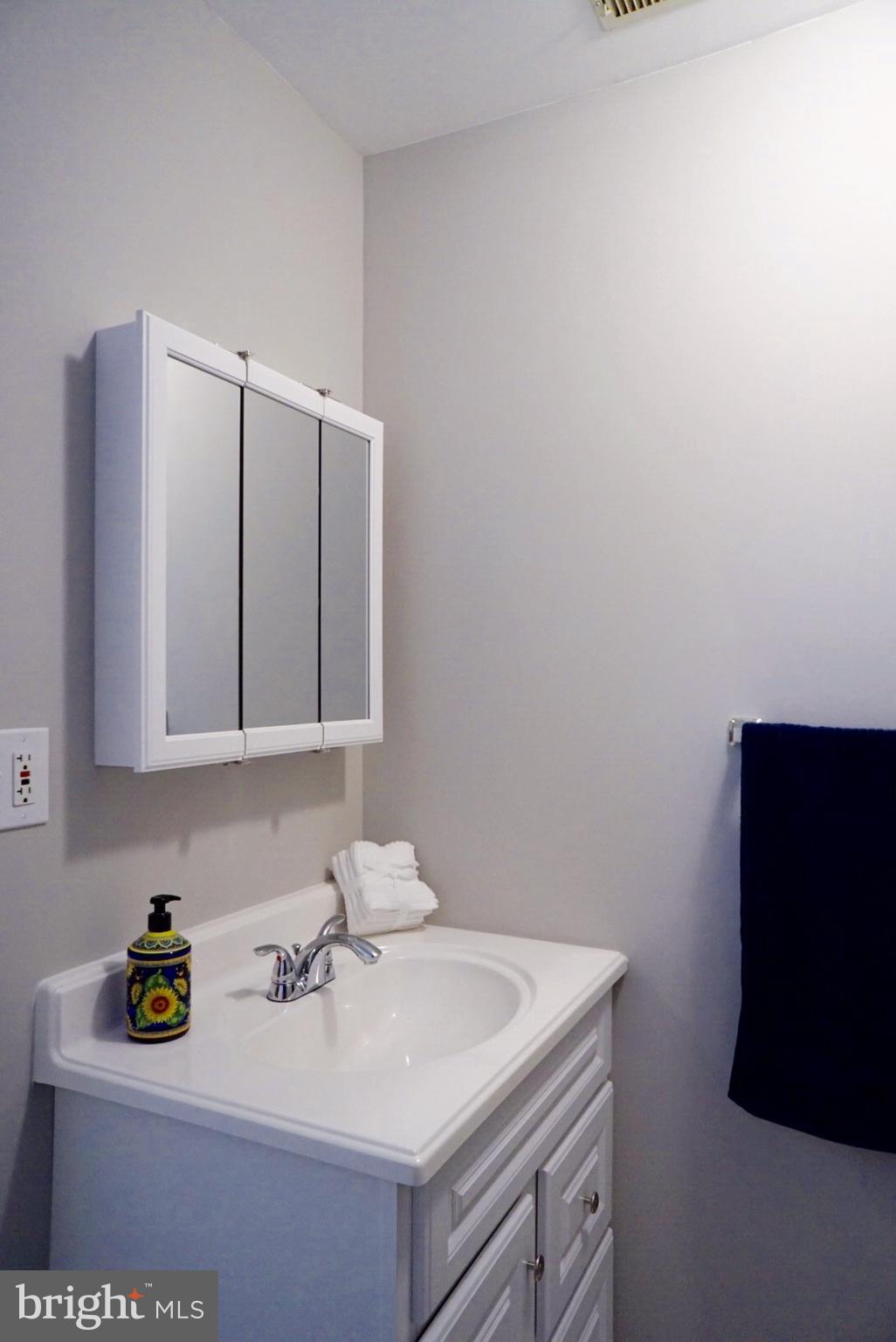 8244 Cornwall Road Baltimore, MD 21222 - Photo 21 of 30 a bathroom with a sink and a mirror