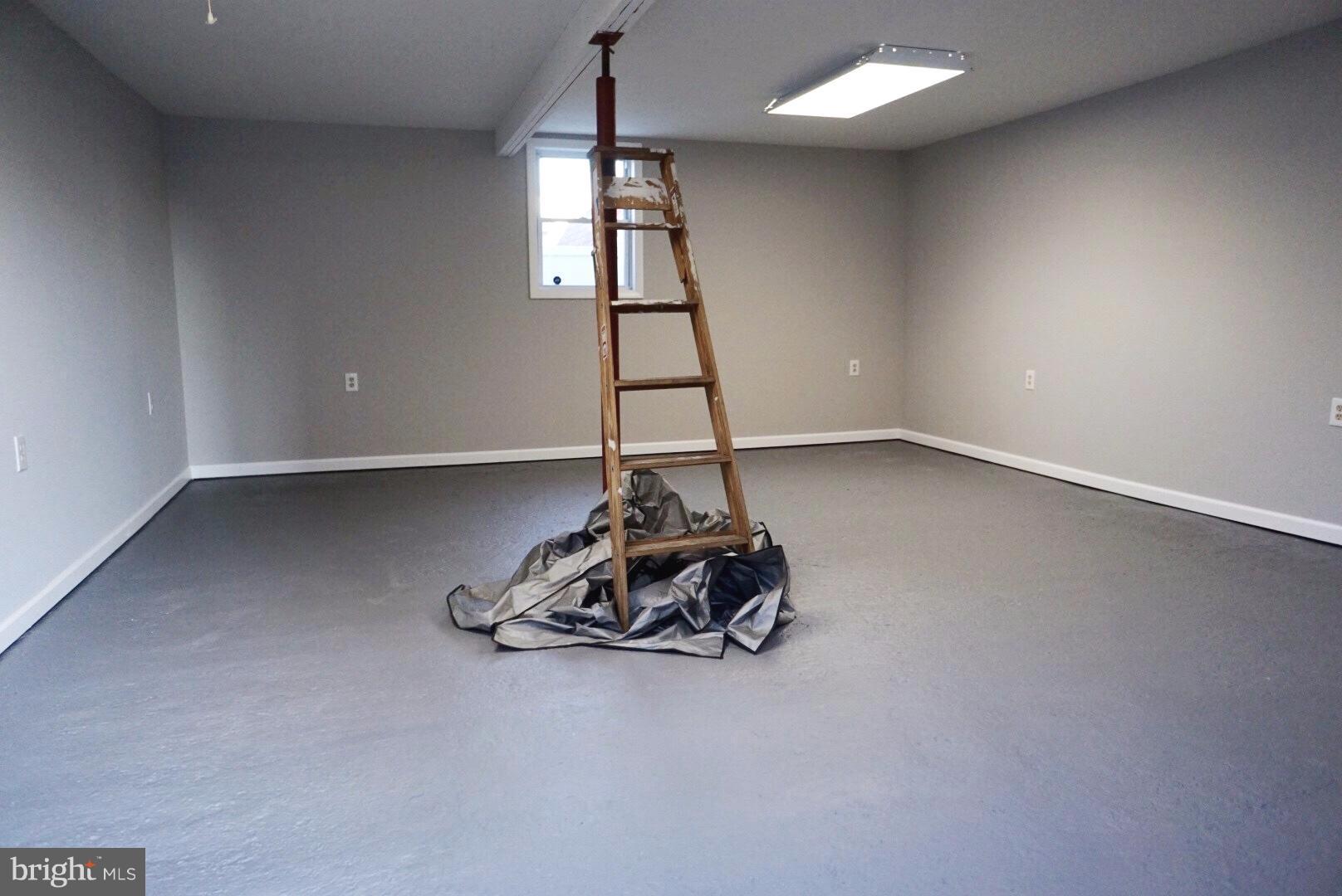 8244 Cornwall Road Baltimore, MD 21222 - Photo 27 of 30 a room with gym equipment and a window