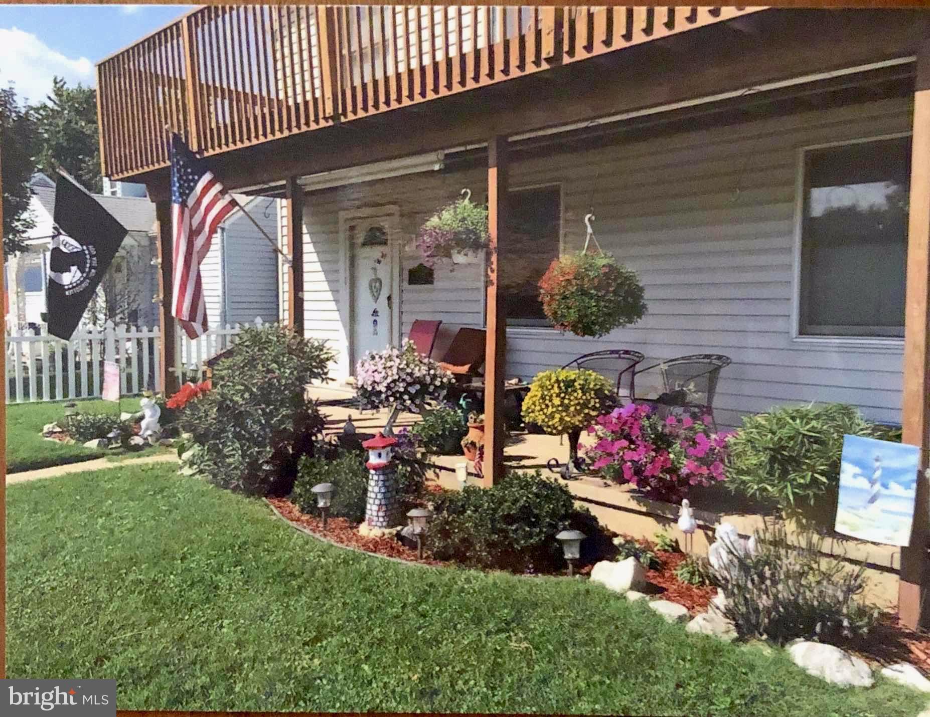 8244 Cornwall Road Baltimore, MD 21222 - Photo 30 of 30 a view of a house with a yard and potted plants