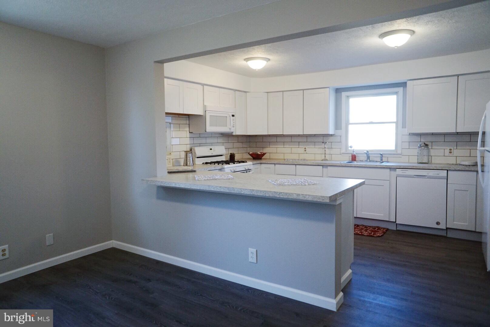 8244 Cornwall Road Baltimore, MD 21222 - Photo 5 of 30 a kitchen with a sink window and cabinets