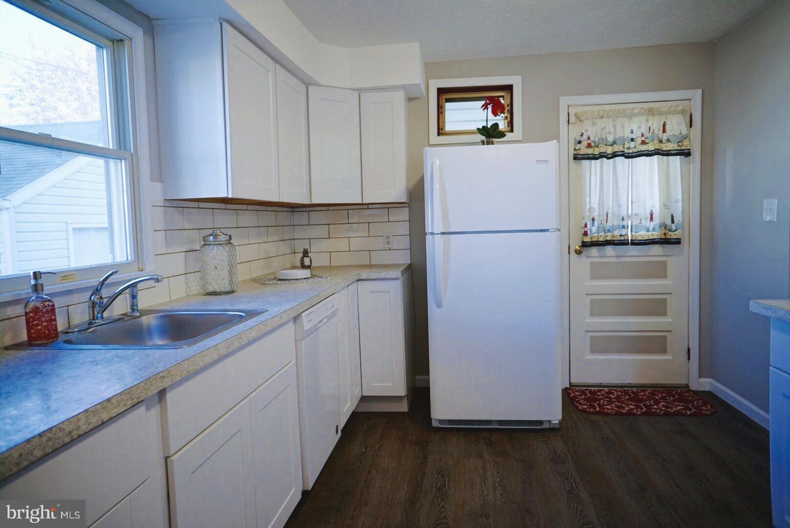 8244 Cornwall Road Baltimore, MD 21222 - Photo 7 of 30 a kitchen with a refrigerator and a sink