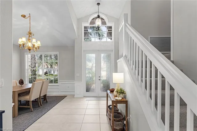 a view of a dining room with furniture and chandelier