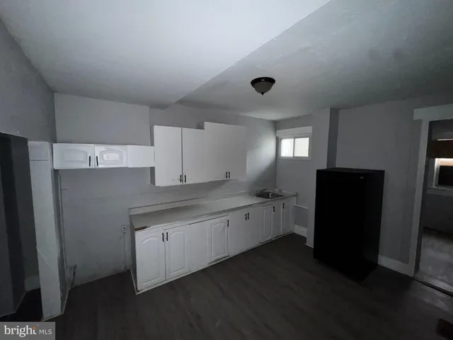 a kitchen with a sink and refrigerator