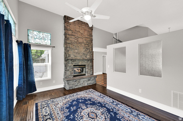 4792 Glasmann Way South Ogden, UT 84403 - Photo 38 of 70 Stone-clad fireplace extending to the vaulted ceiling, complemented by wood-finish flooring and a ceiling fan