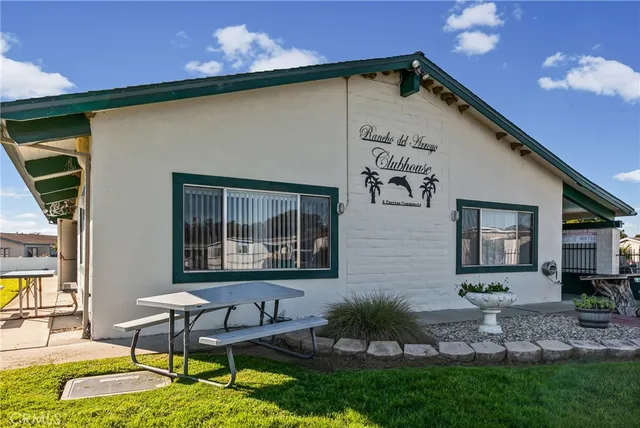 a kitchen with stainless steel appliances granite countertop a sink a stove a refrigerator and cabinets