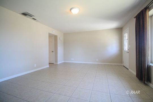 237 South American Street Ridgecrest, CA 93555 - Photo 5 of 26 an empty room with white walls and tiles