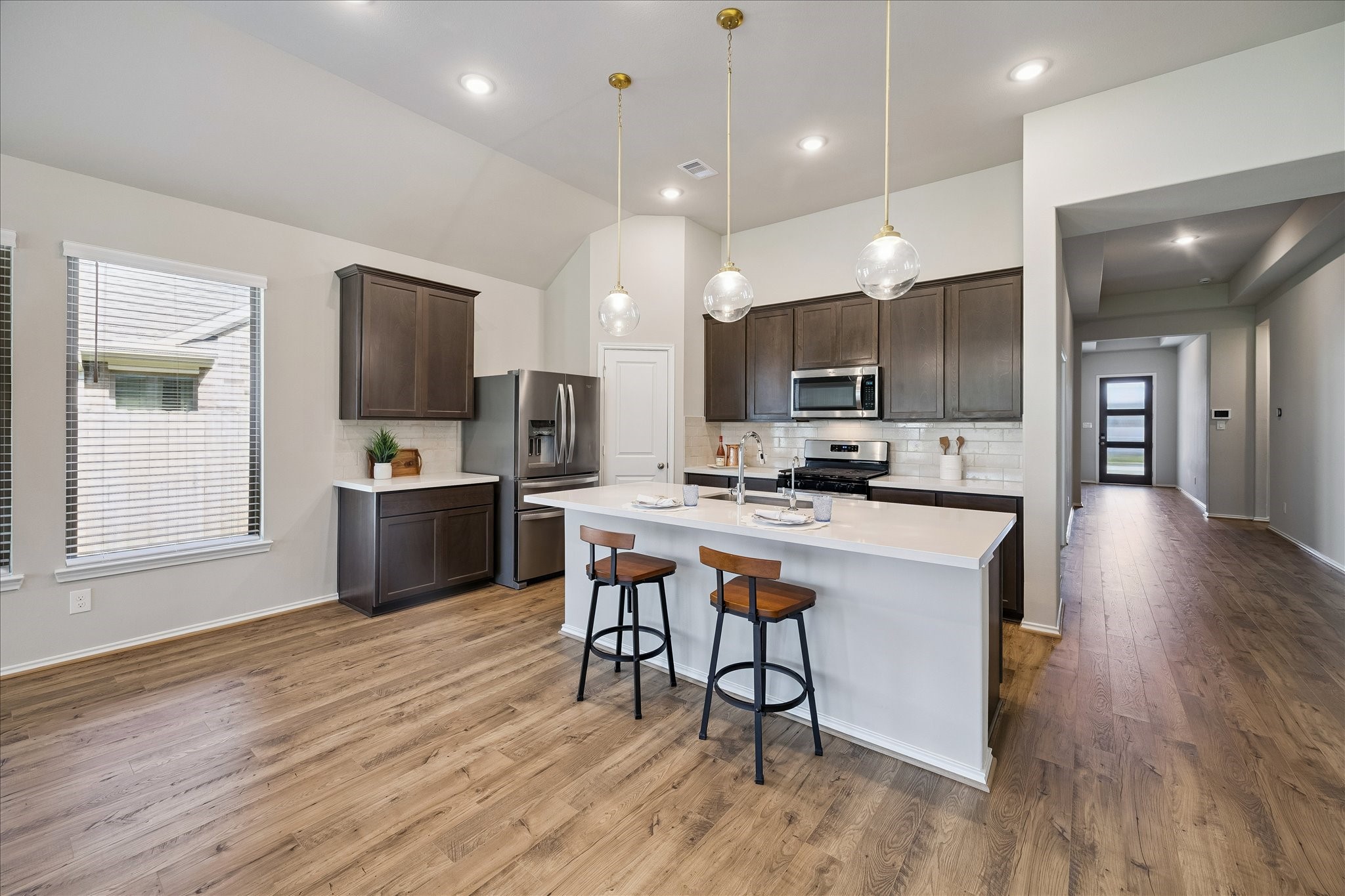 3212 Bright Maple Dr Spring Spring, TX 77386 - Photo 7 of 28 Speaking of kitchens, this one will bring out your inner chef. This gourmet kitchen features an oversized island, quartz counters, and stainless steel steel appliances.