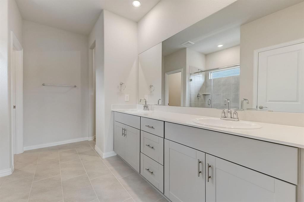 1405 Winters Way McKinney, TX 75071 - Photo 19 of 32 Bathroom with vanity, tile patterned floors, and walk in shower