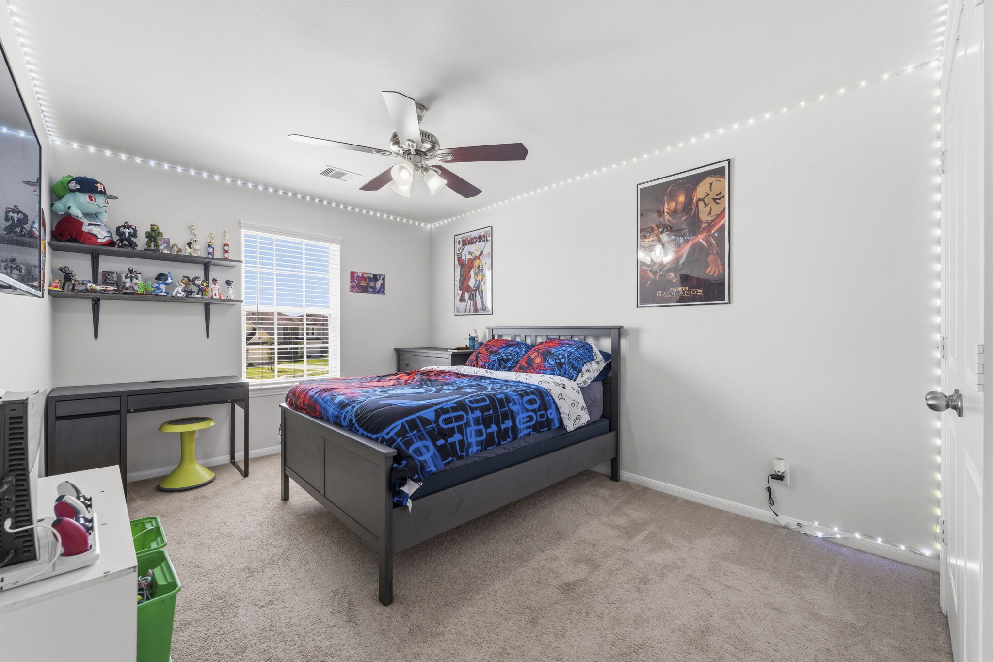 2401 Abbot Brk Drive Rosharon, TX 77583 - Photo 31 of 50 This generously-sized secondary bedroom offers plush carpeting, a spacious wall closet, and a sunlit window with blinds that creates a bright and welcoming atmosphere. A lighted ceiling fan adds comfort and style, while convenient hallway access connects to a well-appointed shared bath serving Bedrooms 3 and 4.