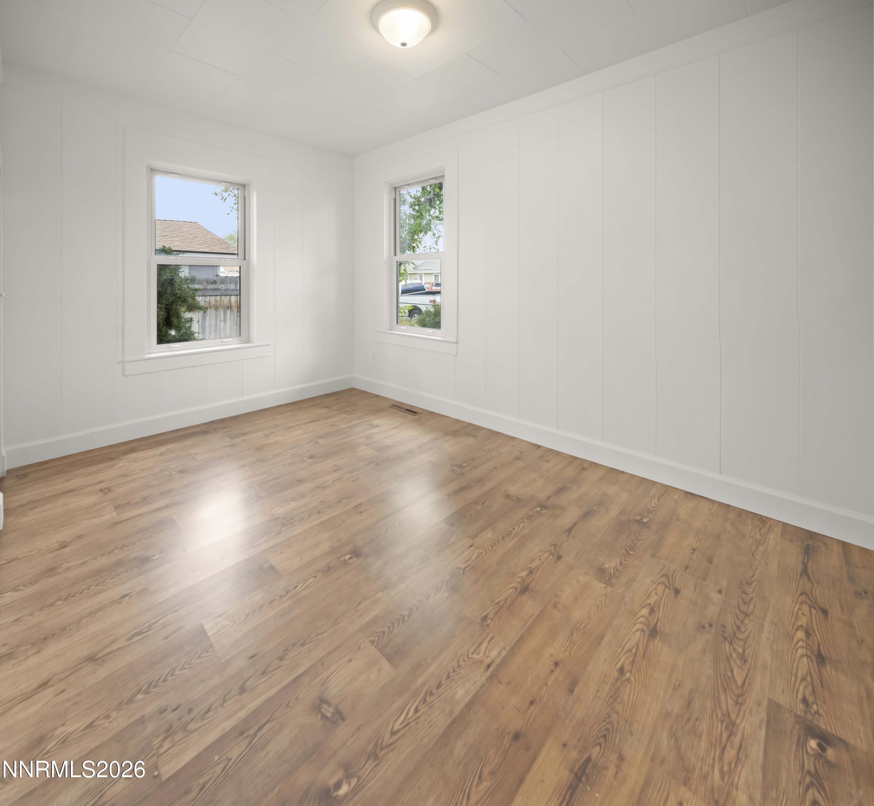 511 Churchill Street Fallon, NV 89406 - Photo 31 of 37 an empty room with wooden floor and windows