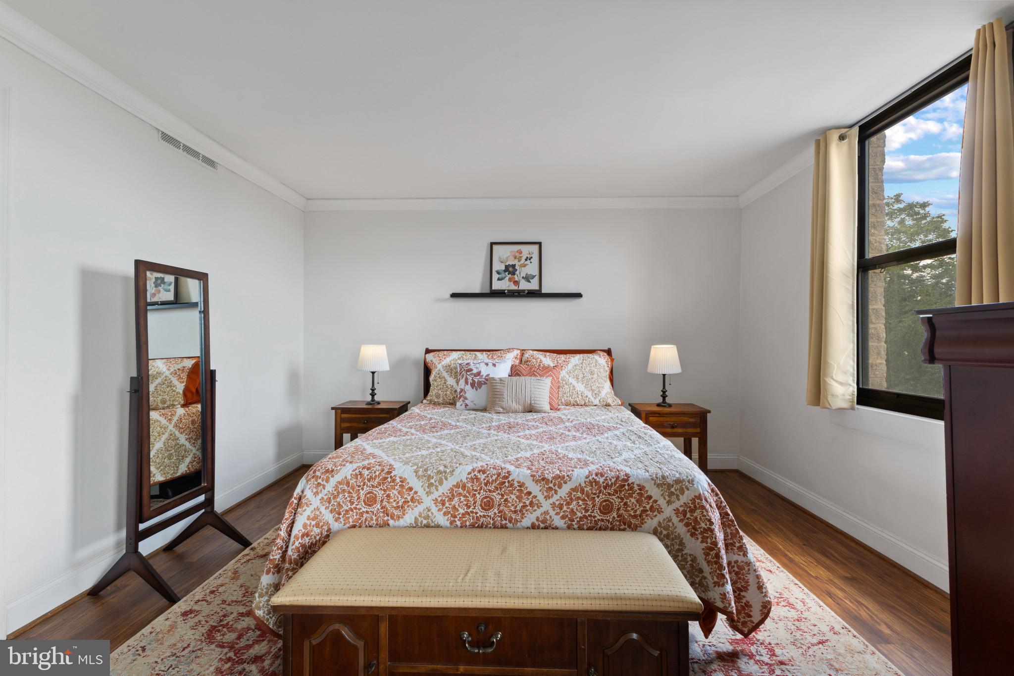 4600 Duke Street, Unit 613 Alexandria, VA 22304 - Photo 13 of 32 a bed sitting in a bedroom next to a window