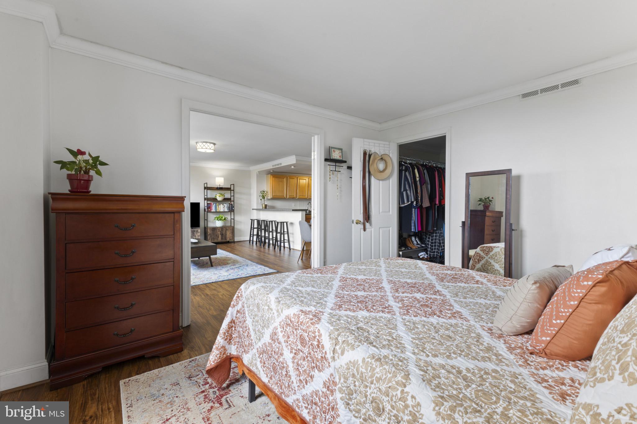 4600 Duke Street, Unit 613 Alexandria, VA 22304 - Photo 14 of 32 a bed room with a bed and a dresser