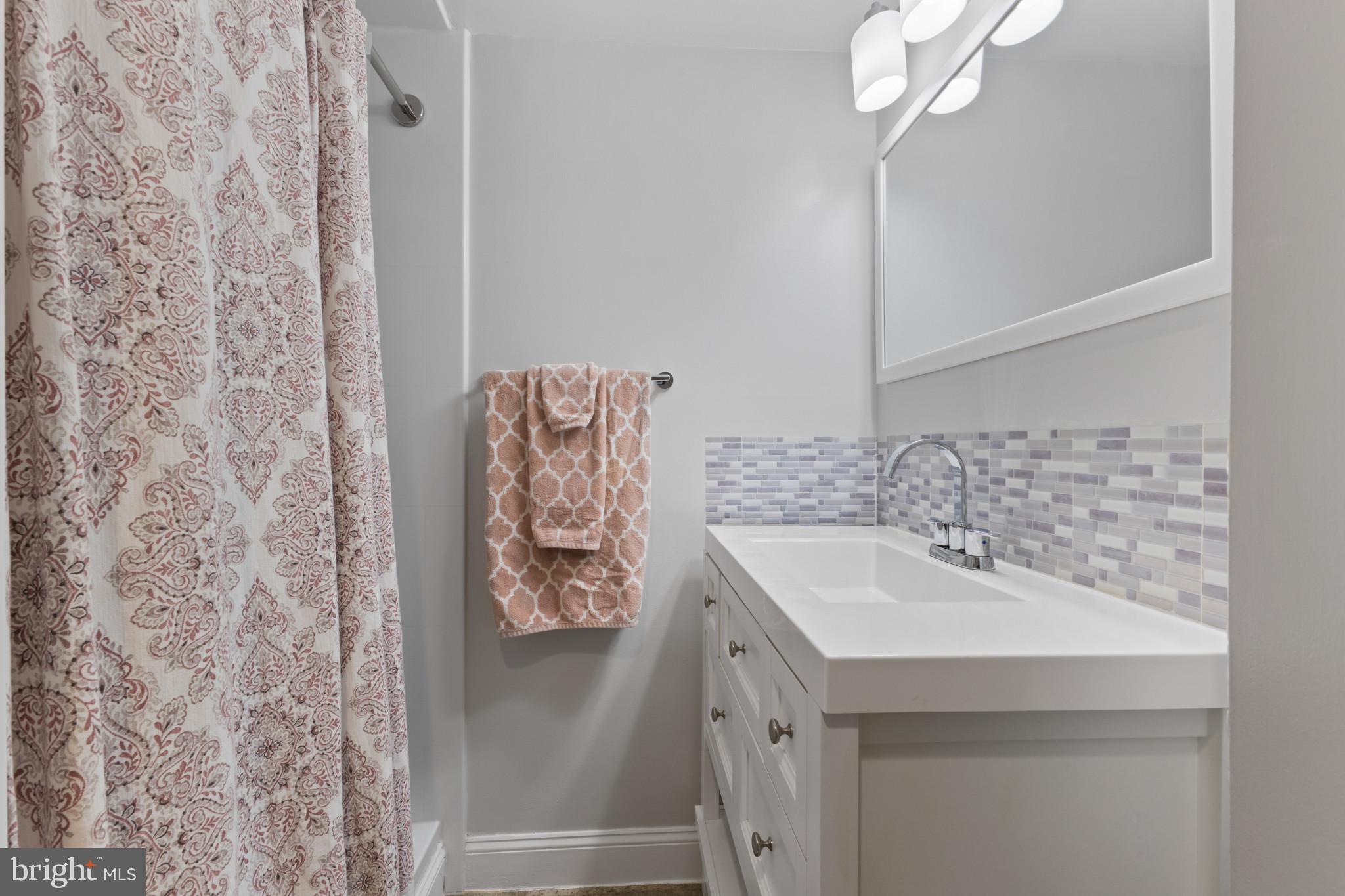 4600 Duke Street, Unit 613 Alexandria, VA 22304 - Photo 16 of 32 a bathroom with a sink and a mirror