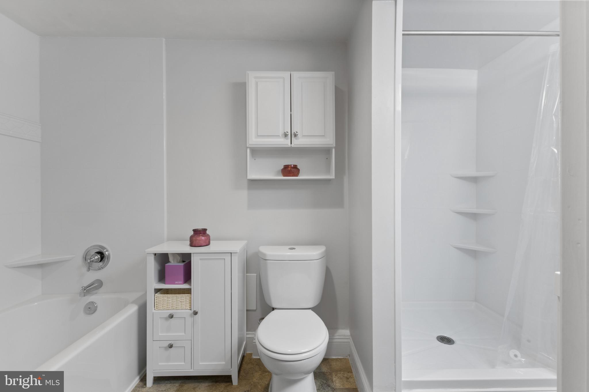 4600 Duke Street, Unit 613 Alexandria, VA 22304 - Photo 17 of 32 a white toilet sitting next to a bath tub