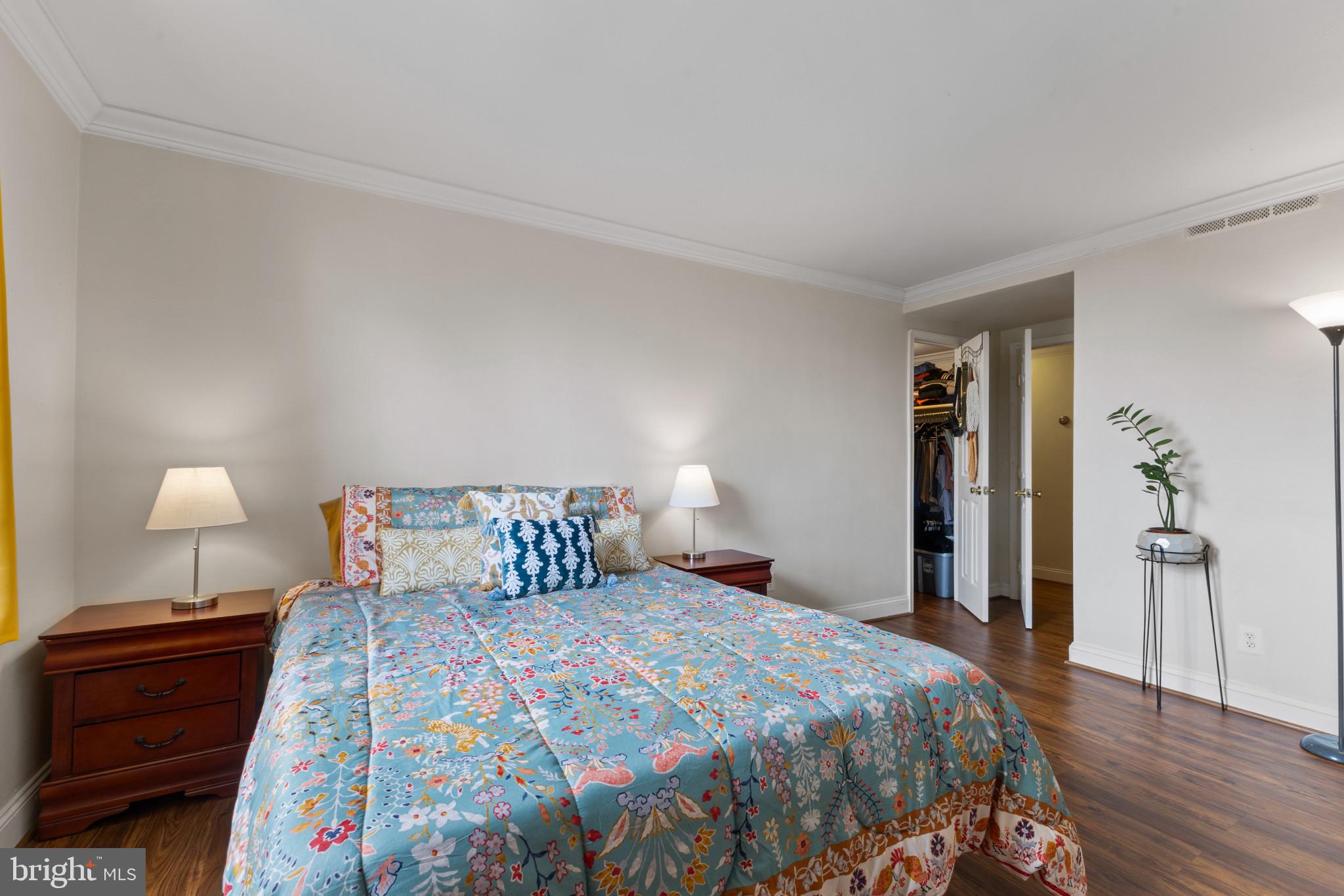 4600 Duke Street, Unit 613 Alexandria, VA 22304 - Photo 21 of 32 a bedroom with a bed and wooden floor