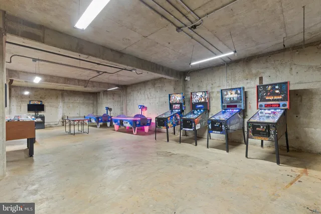 a view of a kitchen with a dining table chairs wooden floor and a large window