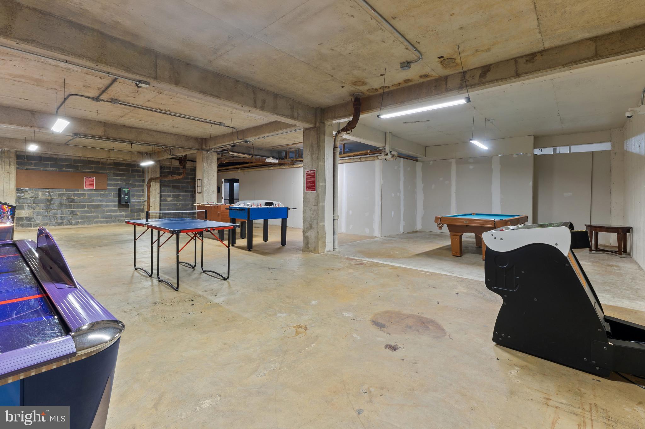 4600 Duke Street, Unit 613 Alexandria, VA 22304 - Photo 30 of 32 a view of a kitchen with a dining table chairs wooden floor and a large window