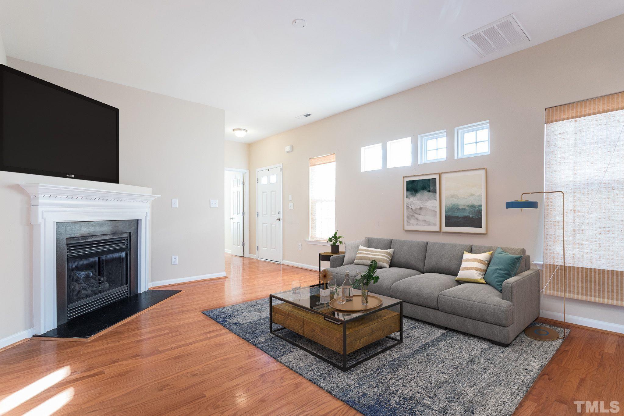 2153 Metacomet Way Raleigh, NC 27604 - Photo 5 of 30 a living room with furniture a fireplace and a flat screen tv