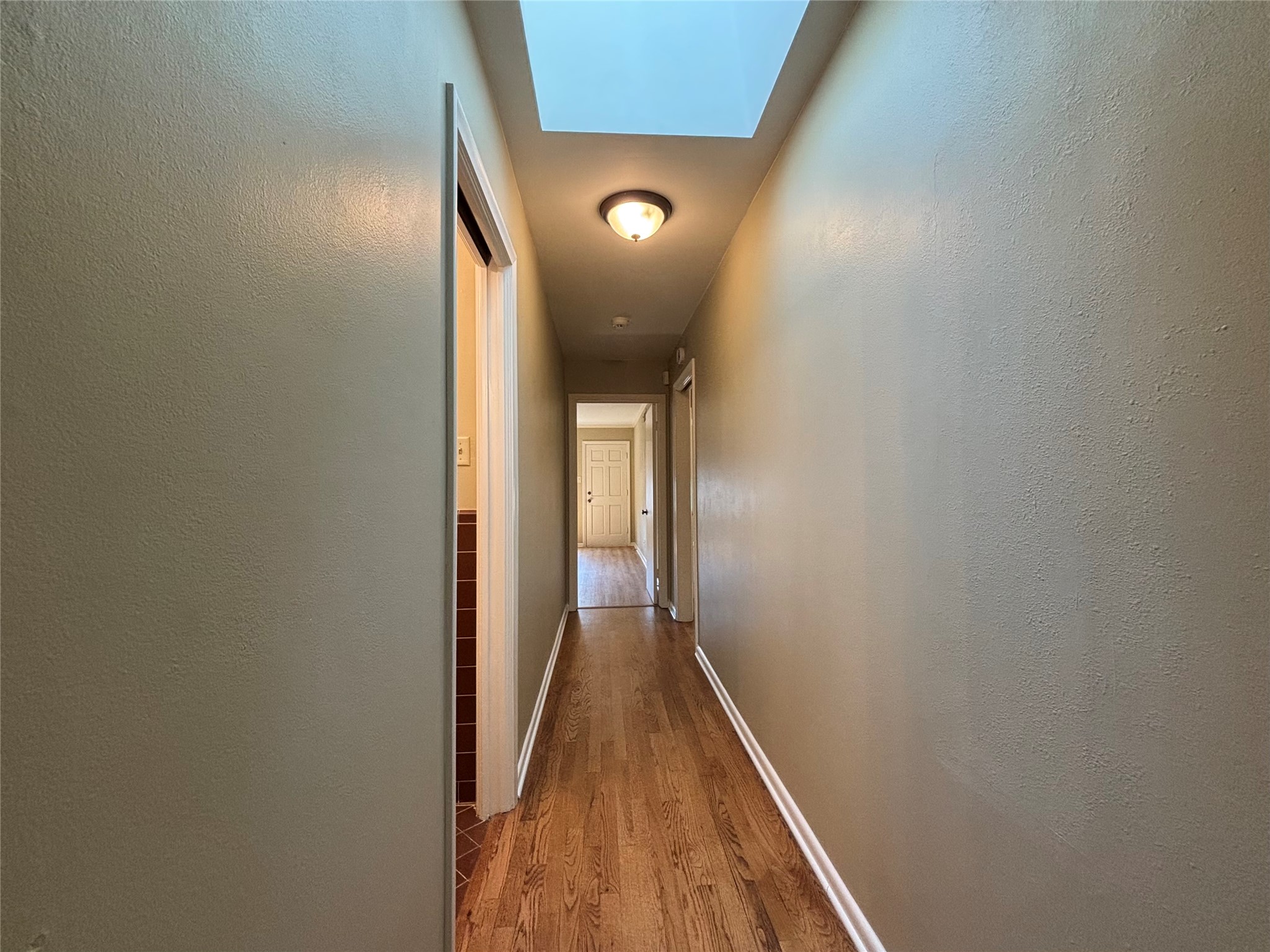 3509 River Road Austin, TX 78703 - Photo 25 of 40 Main hall connecting first 3 bedrooms. Has skylight!