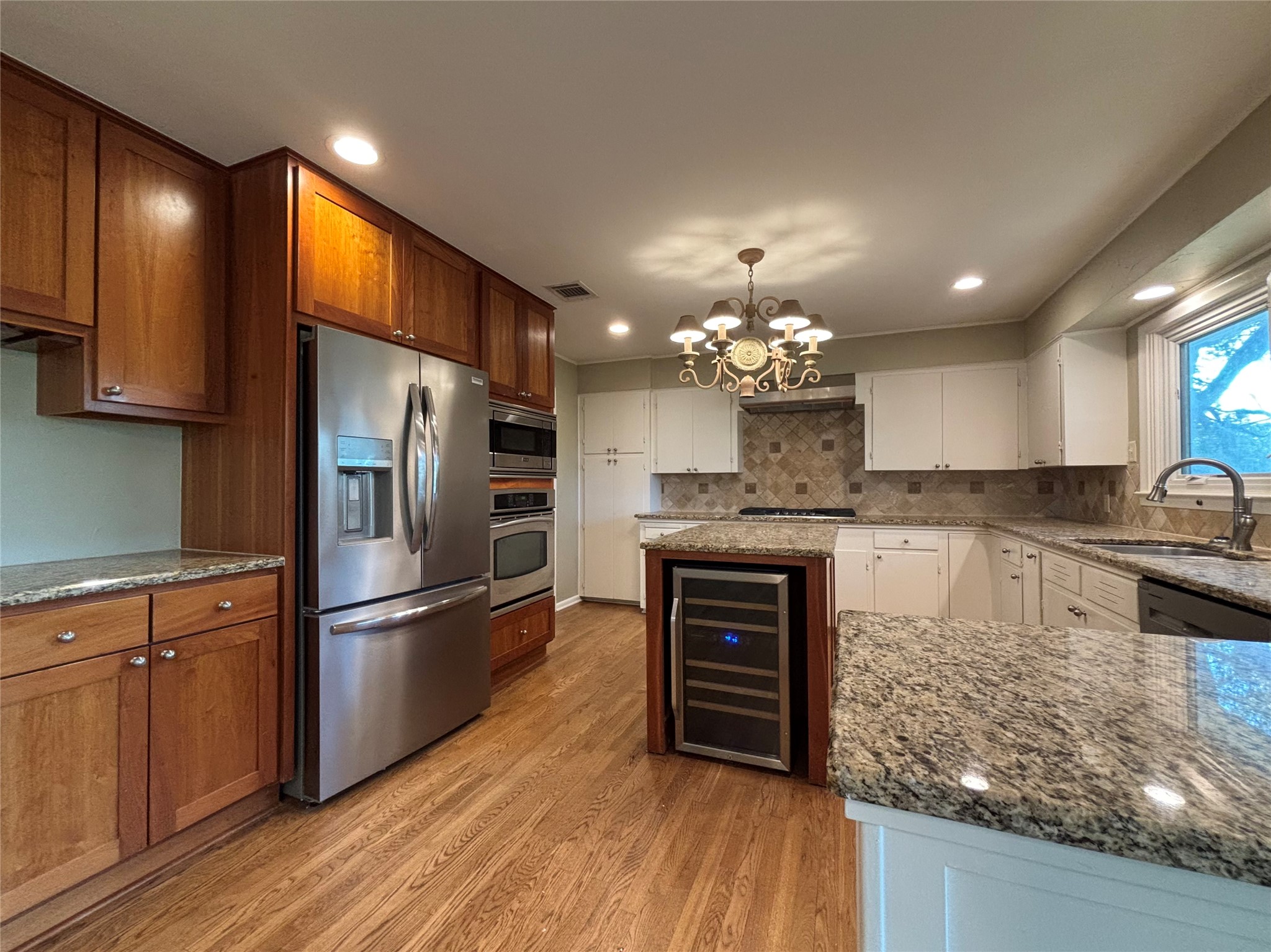 3509 River Road Austin, TX 78703 - Photo 5 of 40 Spacious, bright kitchen. Island with wine fridge. Gas cooktop. Built in microwave & oven