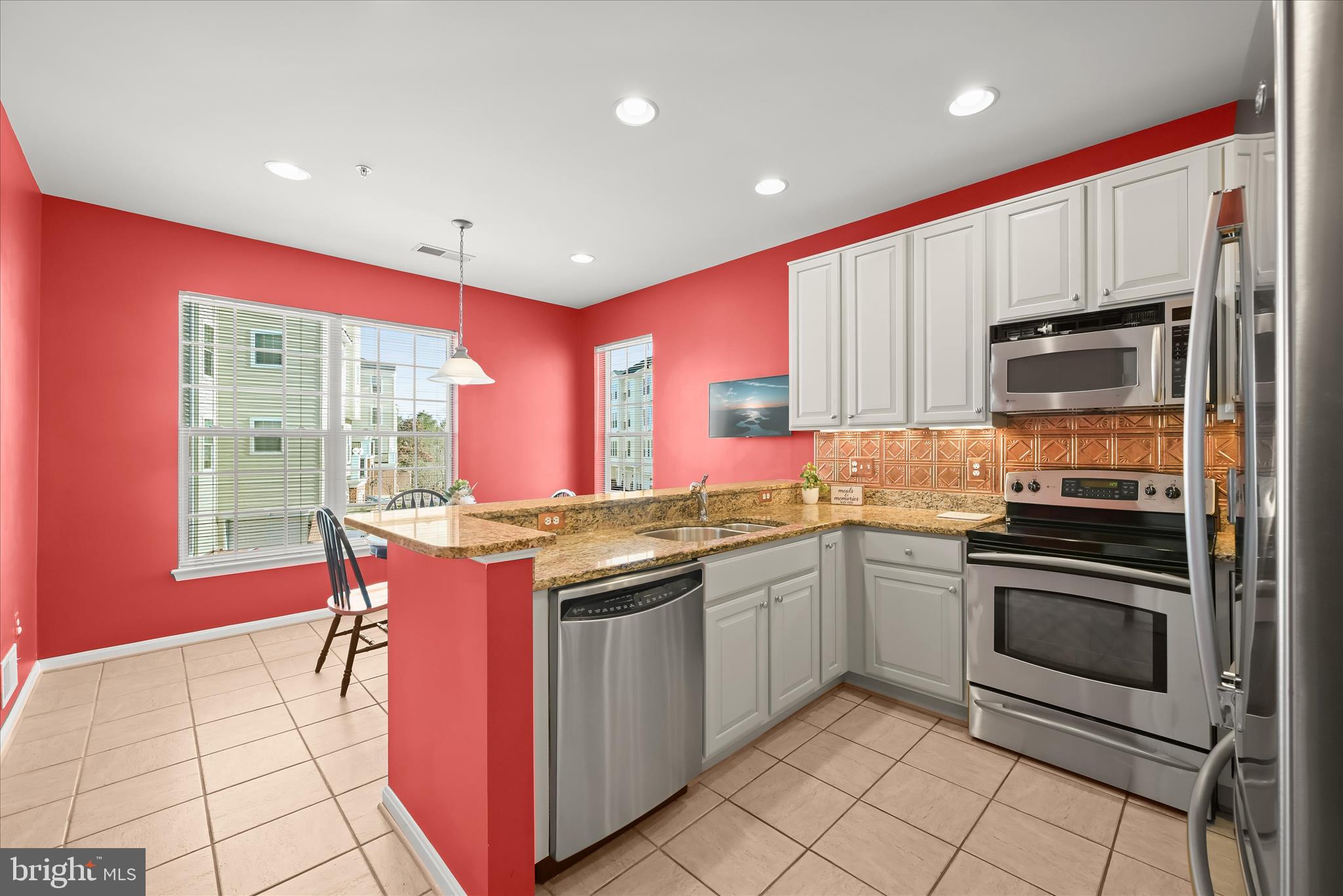 7305 Maplecrest Road, Unit 207 Elkridge, MD 21075 - Photo 12 of 50 a kitchen with stainless steel appliances granite countertop a stove a sink and a microwave