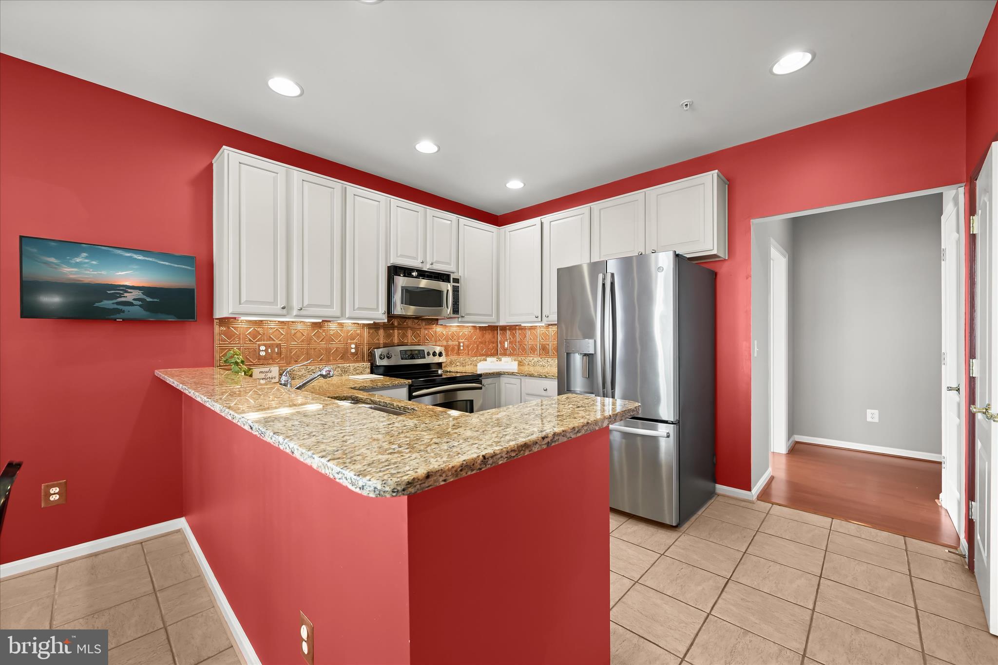 7305 Maplecrest Road, Unit 207 Elkridge, MD 21075 - Photo 17 of 50 a kitchen with stainless steel appliances granite countertop a refrigerator and a sink