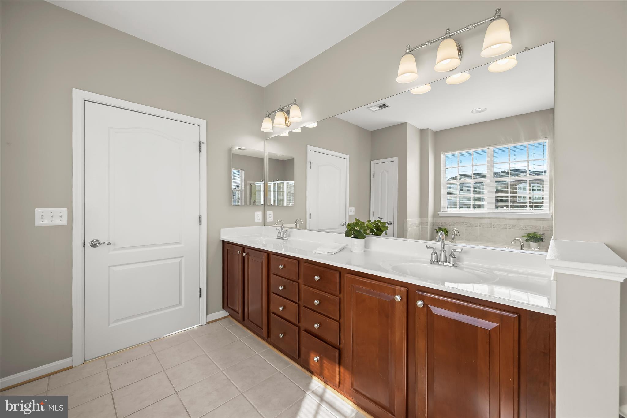 7305 Maplecrest Road, Unit 207 Elkridge, MD 21075 - Photo 27 of 50 a spacious bathroom with a double vanity sink and a mirror