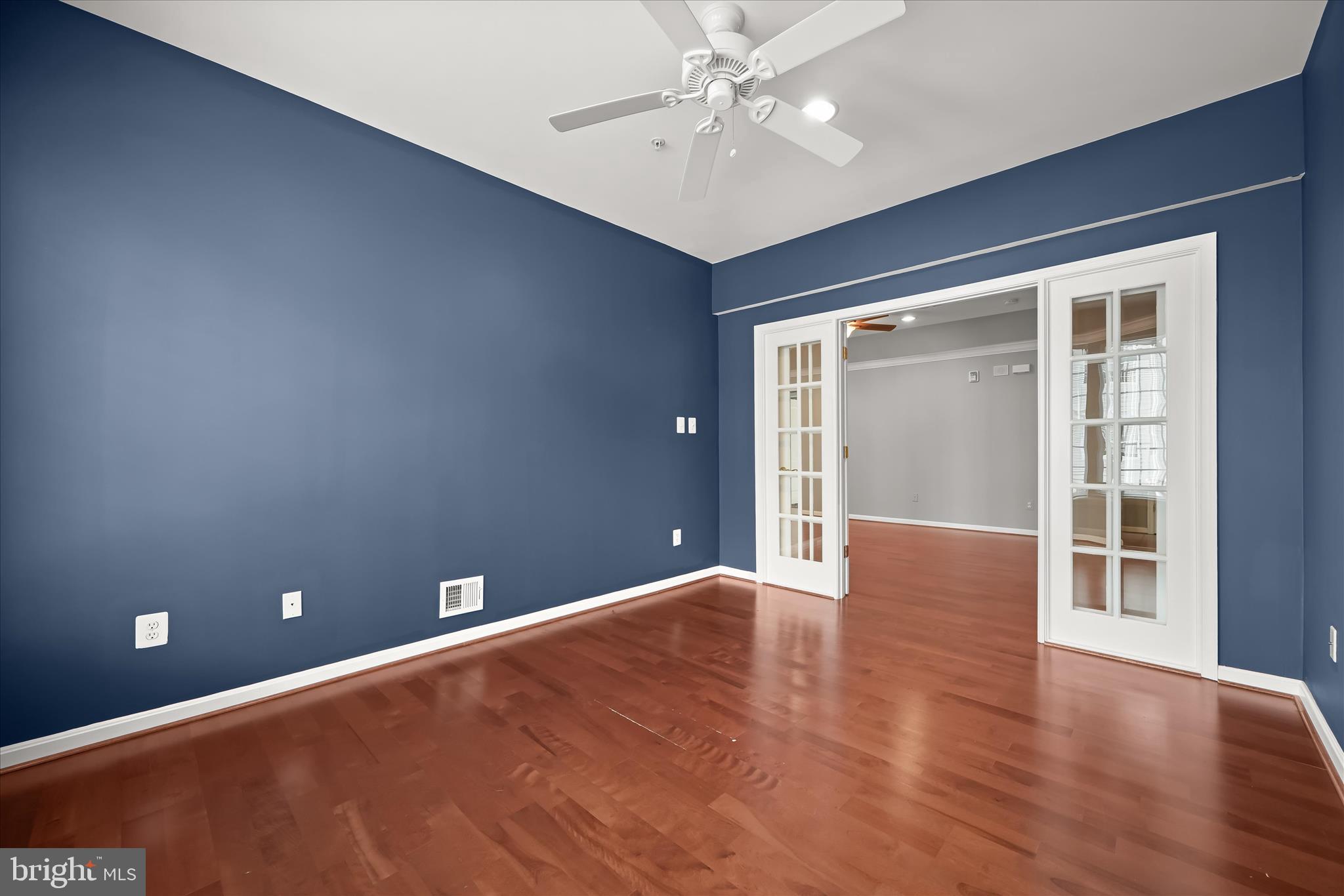 7305 Maplecrest Road, Unit 207 Elkridge, MD 21075 - Photo 30 of 50 a view of an empty room with wooden floor and a window
