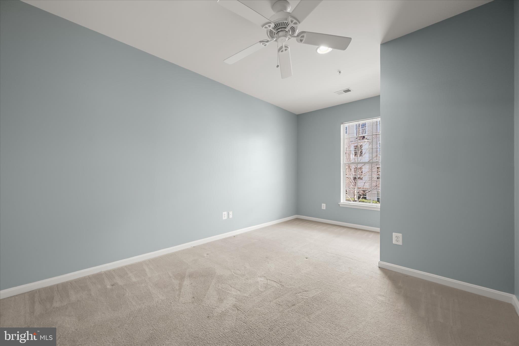 7305 Maplecrest Road, Unit 207 Elkridge, MD 21075 - Photo 37 of 50 en empty room with windows and chandelier fan