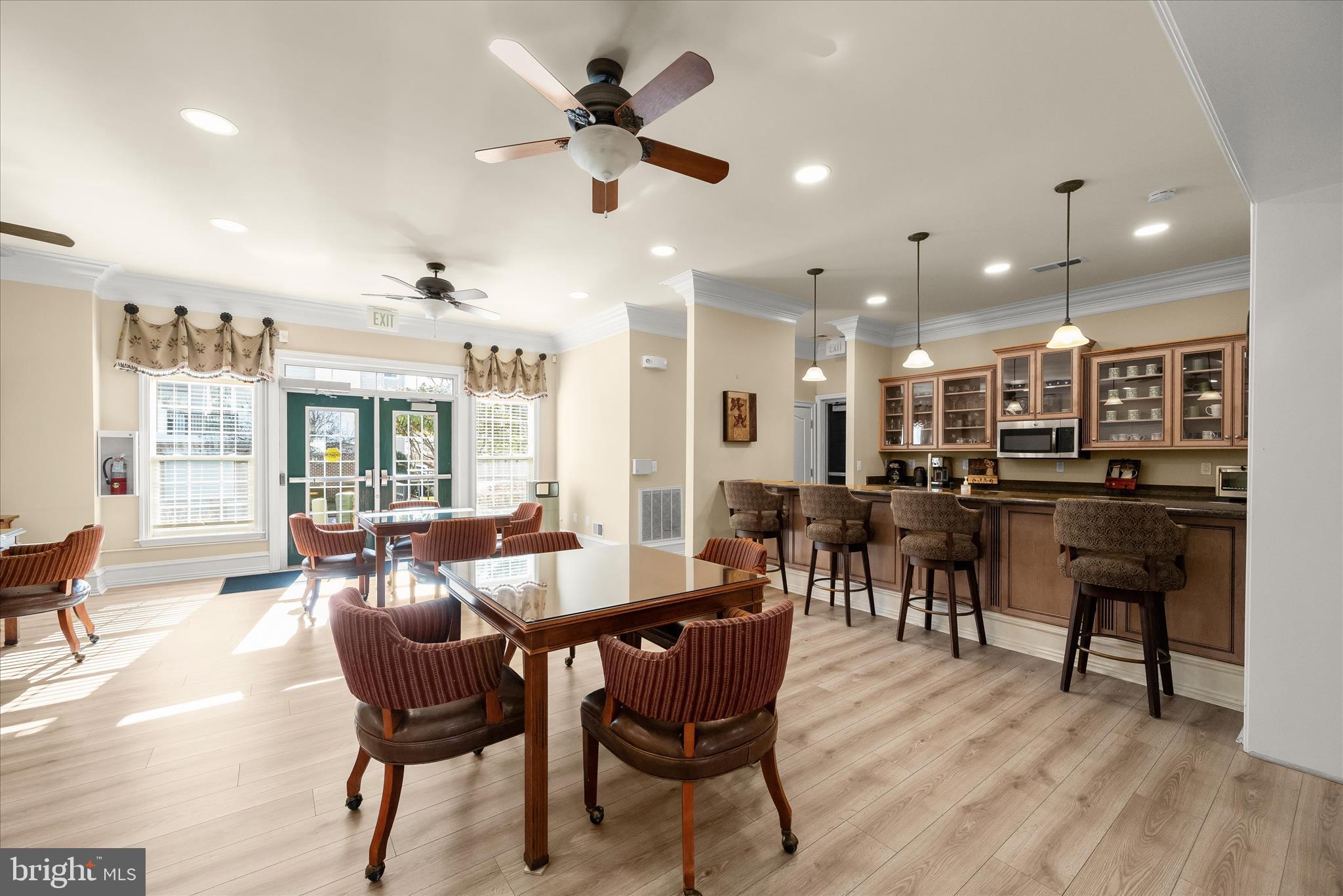 7305 Maplecrest Road, Unit 207 Elkridge, MD 21075 - Photo 43 of 50 a view of a dining room with furniture window and wooden floor