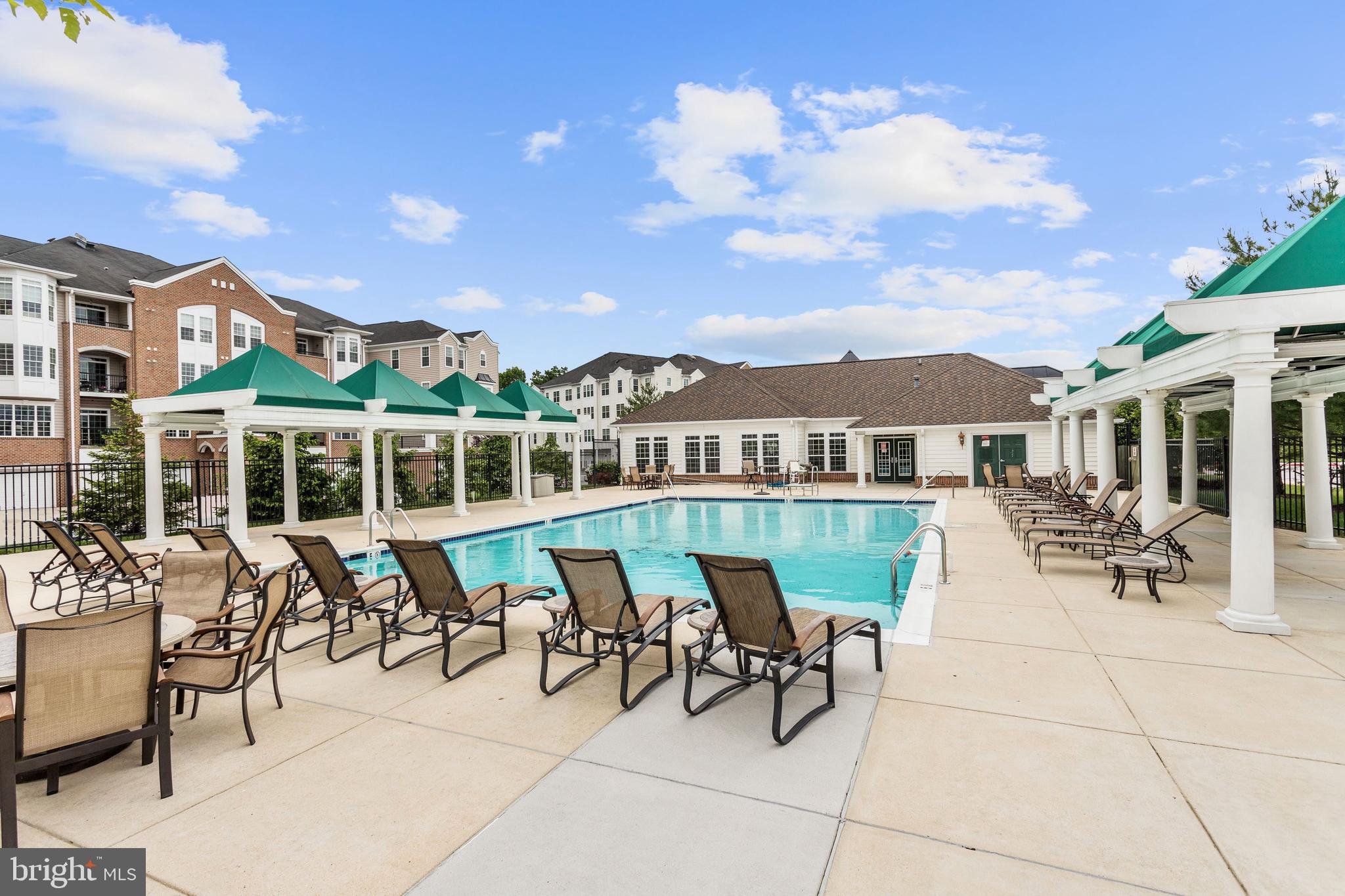 7305 Maplecrest Road, Unit 207 Elkridge, MD 21075 - Photo 45 of 50 a view of a patio with table and chairs with wooden floor and fence