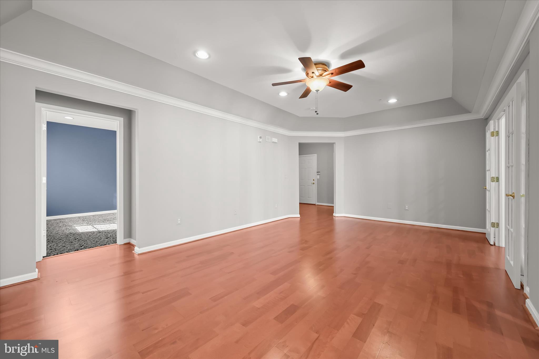 7305 Maplecrest Road, Unit 207 Elkridge, MD 21075 - Photo 7 of 50 a view of an empty room with a ceiling fan and window