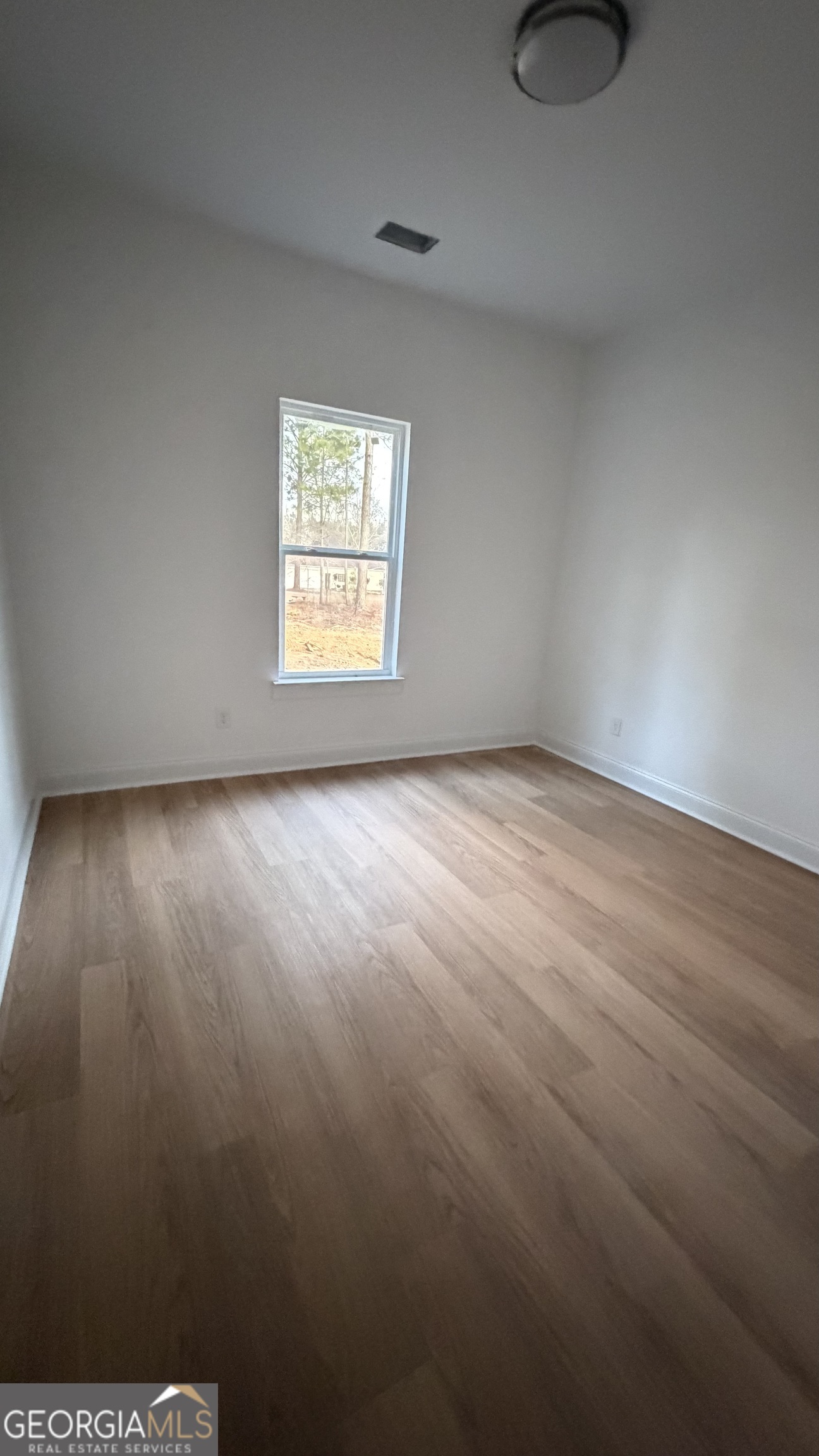 336 Mace Cannon Road Dublin, GA 31021 - Photo 6 of 18 a view of an empty room and window