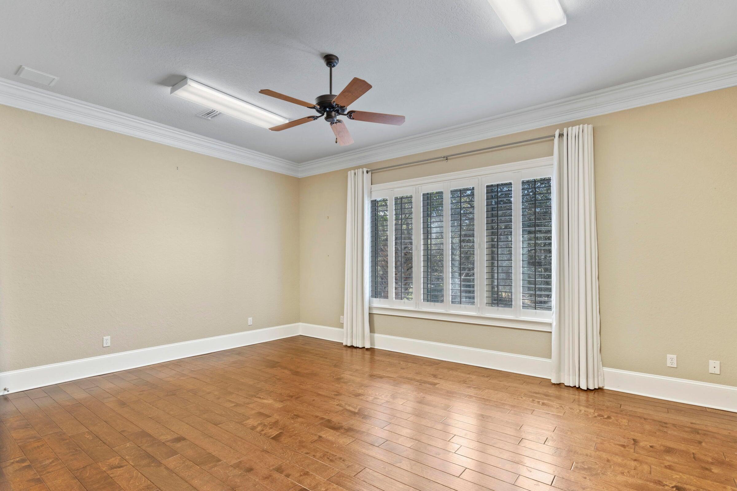 322 Emerald Ridge Santa Rosa Beach, FL 32459 - Photo 20 of 43 a view of an empty room with wooden floor and a window