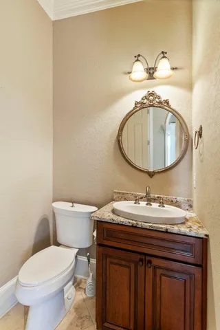 a bathroom with a granite countertop sink toilet mirror and shower