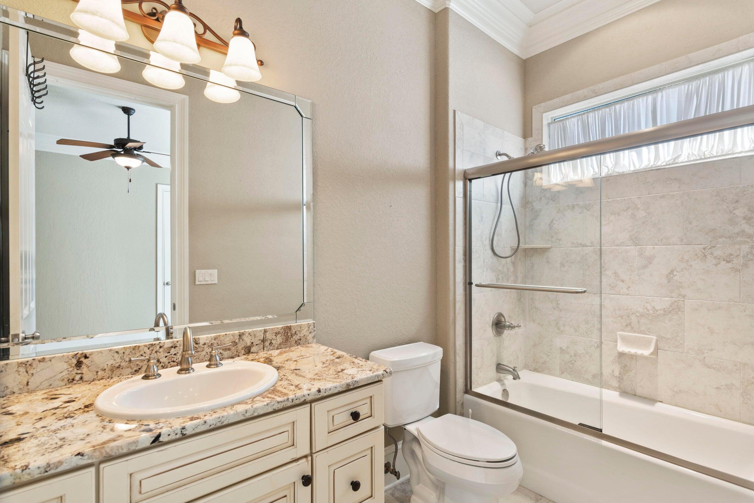 322 Emerald Ridge Santa Rosa Beach, FL 32459 - Photo 23 of 43 a bathroom with a granite countertop sink toilet mirror and shower